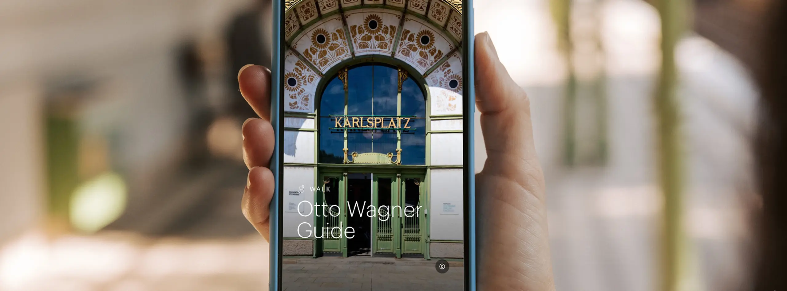 Smartphone displaying ivie's Otto Wagner Karlsplatz Walk Guide, featuring Vienna's Art Nouveau architecture.