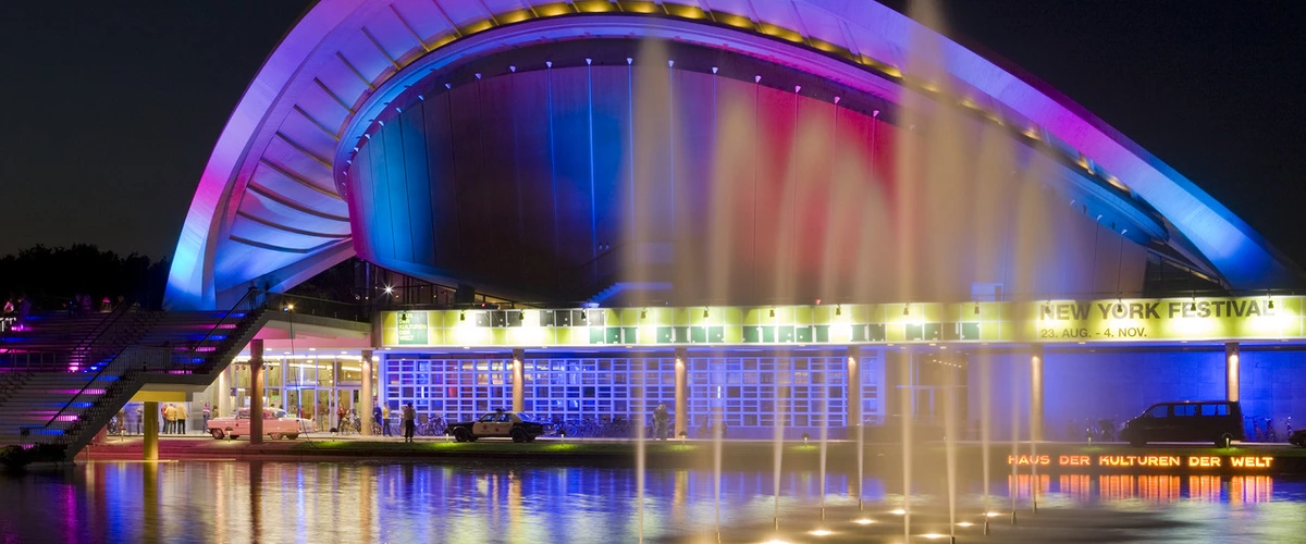 Vibrant illumination of the Haus der Kulturen der Welt with a colorful fountain light show during the Festival of Lights Berlin.