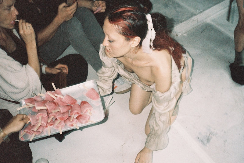 Attendees enjoying pink popsicle desserts during Caique Tizzi and YBDG's 